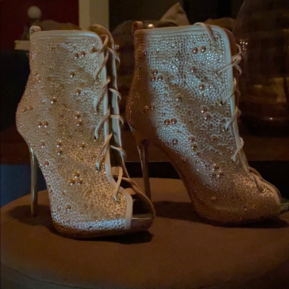 Open toe ankle tie up heeled boots.